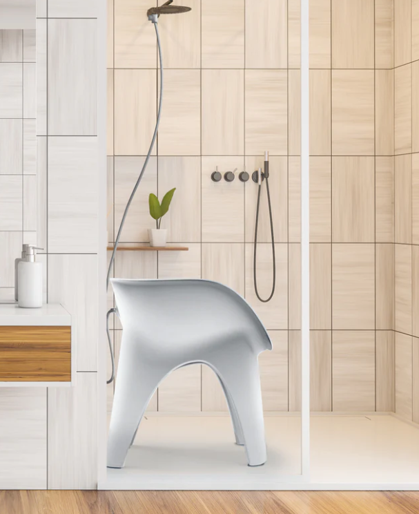 SoSoak shower & sitz bath chair with its hose connected in a tiled shower