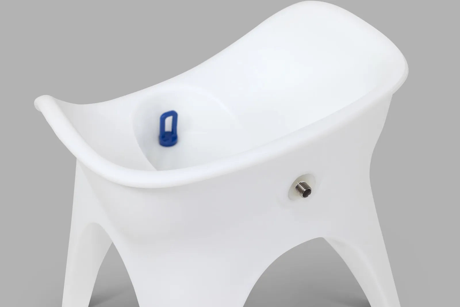 Close-up of the SoSoak seat showing the soaking basin, drain plug, and hose port