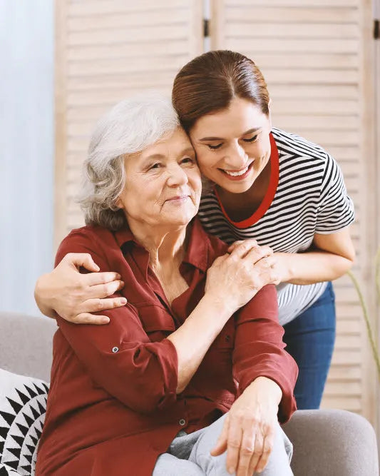 Smiling granddaughter hugging her grandmother
